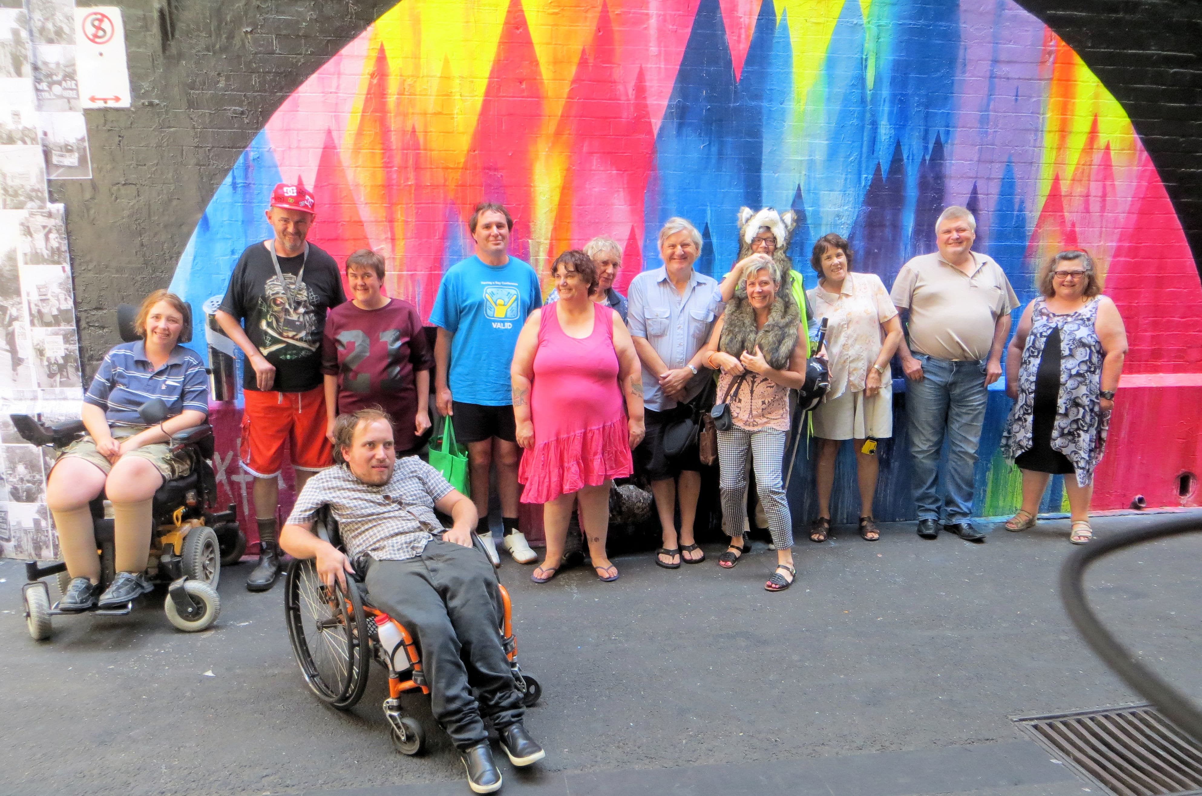 Image of the reinforce committee group standing in front of coloured wall